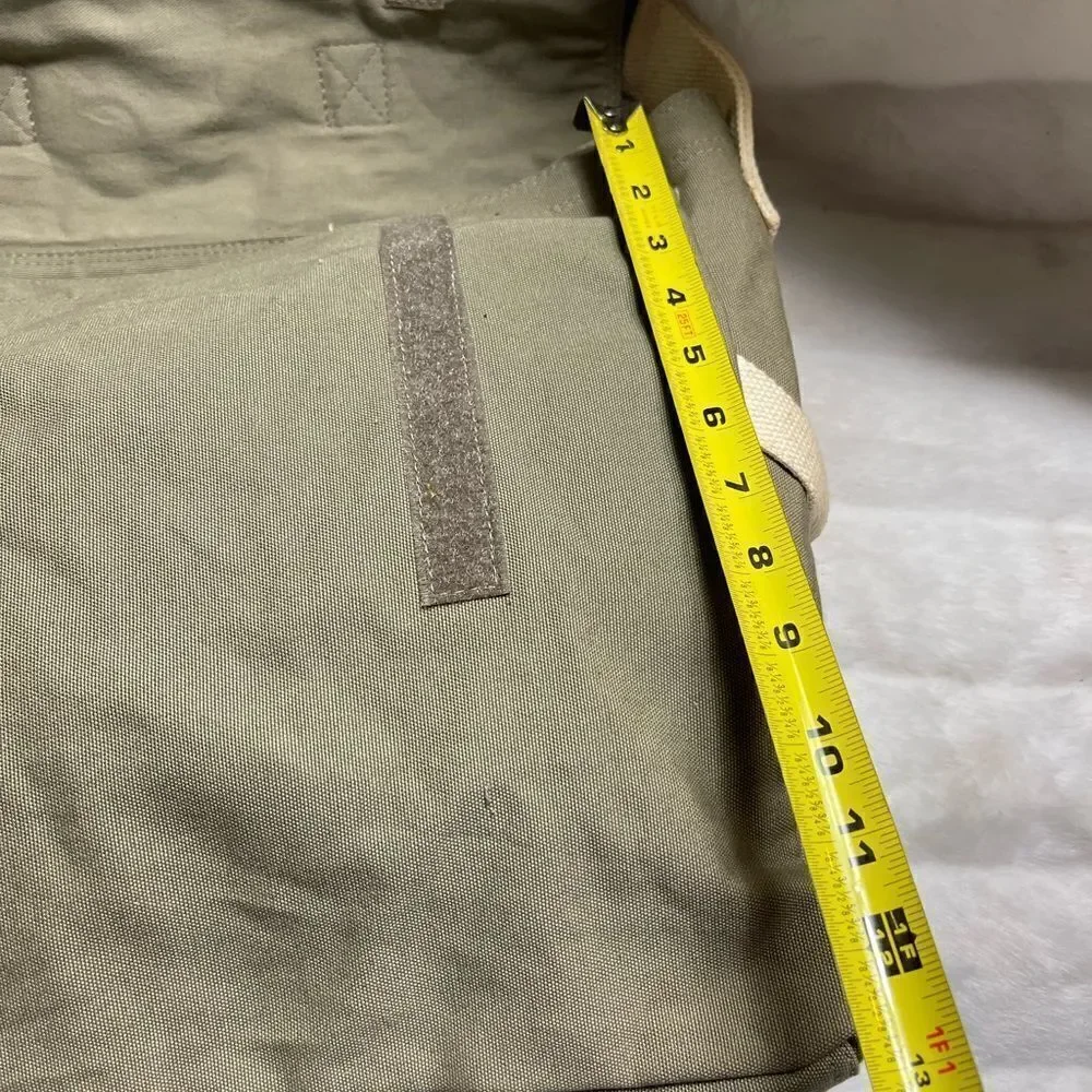 Lucky Brand large canvas olive green messenger bag with adjustable beige strap.